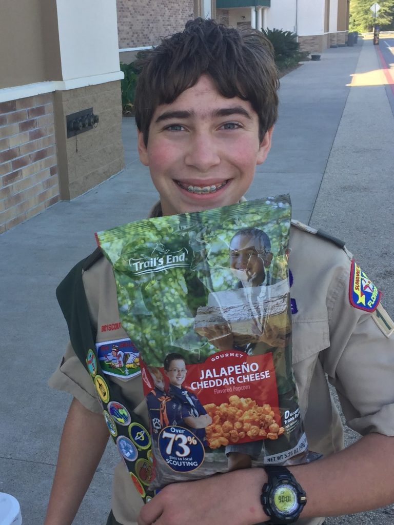 Avner selling popcorn in full uniform.